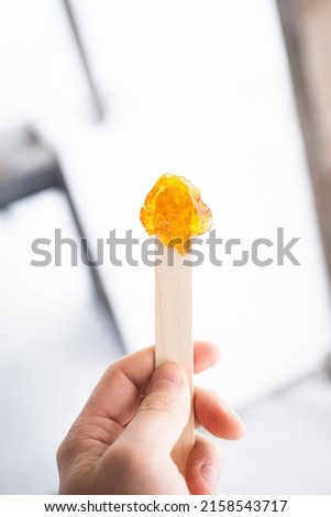 Maple syrup taffy snow candy on a stick specific to Quebec terroir