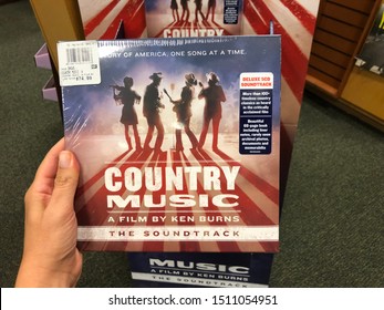 Maplewood, Minnesota - September 20, 2019: Hand Holds Up A CD Of The Popular Ken Burns Country Music Documentary Series On PBS