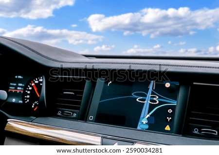 Maps application with GPS navigation on screen in car dashboard panel.Intelligent digital information location system for traveling with route in luxury automobile.