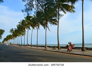 Maputo, Mozambique - December 12, 2008: In The Capital Of Mozambique. The Road Along The Coast Of The Indian Ocean. Quay. Unknown City Residents Go About Their Business. The Road With Cars.