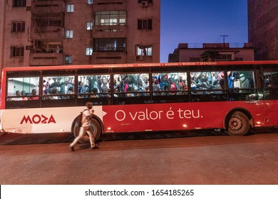 Maputo, Mozambique: May 15, 2019: A Man Trying To Catch Crowded Bus In The Evening