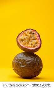 Maracuja or Brazilian tropical passion fruit studio food still life against a yellow background