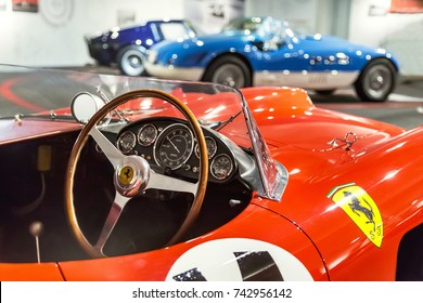 Maranello, Italy - July 26, 2017: Exhibition In The Famous Ferrari Museum (Enzo Ferrari) Of Sport Cars, Race Cars And F1. Dashboard And Steering Wheel Of Red Vintage Classic Sport, Race Car. Close Up.