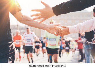 Marathon. Child's hand giving highfive. Concept of support at sport. 