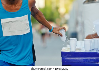 Marathon Runner Picking Up Water At Service Point