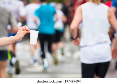 Marathon Runner Picking Up Water At Service Point 