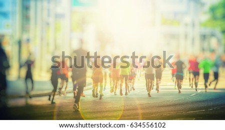 marathon runners in the city background