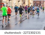 Marathon runners crowd, participants start running the half-marathon in the city streets, crowd of joggers in motion, group athletes outdoor training competition