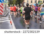 Marathon runners crowd, participants start running the half-marathon in the city streets, crowd of joggers in motion, group athletes outdoor training competition