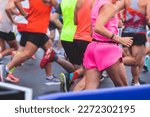 Marathon runners crowd, participants start running the half-marathon in the city streets, crowd of joggers in motion, group athletes outdoor training competition