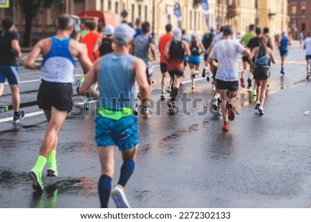 Marathon runners crowd, participants start running the half-marathon in the city streets, crowd of joggers in motion, group athletes outdoor training competition