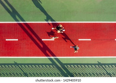 Marathon Runners With Dog. Sport Life Style. Active Couple On Red And Green Bridge. Aerial Drone Top View