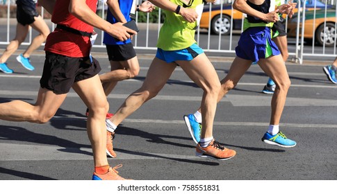 Marathon runners legs running on the road