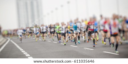 marathon runners ,motion blur running people in the city 