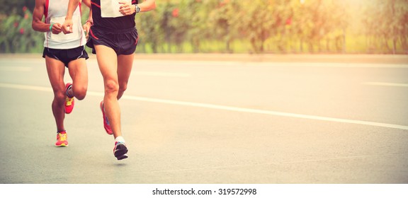 Marathon runners running on city road - Shutterstock ID 319572998