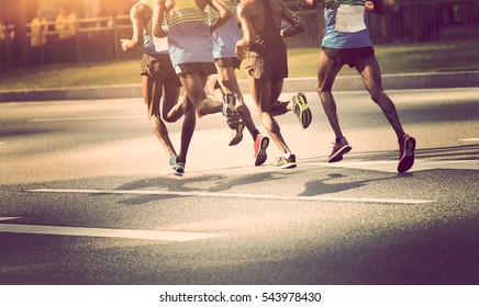 Marathon Runners Running On City Road