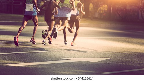 marathon runners running on city road