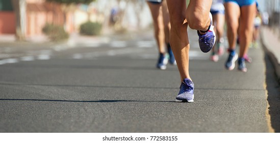 Marathon Runners Running On City Road,detail On Legs