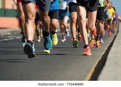 Marathon running in the light of evening,running on city road detail on legs - Shutterstock ID 776440840