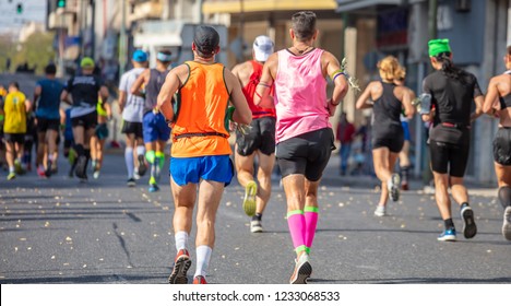 Marathon Running Race, Group Of Runners On City Roads, Back View