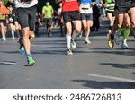 Marathon running race, many runners feet on road racing, sport competition, fitness and healthy lifestyle concept