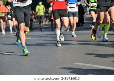 Marathon running race, many runners feet on road racing, sport competition, fitness and healthy lifestyle concept