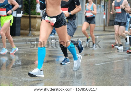 Marathon running race, many runners feet on road racing, woman on sport competition, fitness and healthy lifestyle concept
