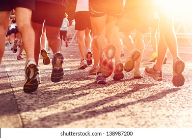 Marathon running race people competing in fitness and healthy active lifestyle feet on road - Shutterstock ID 138987200