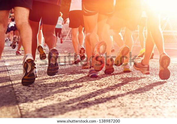 Marathon running race people\
competing in fitness and healthy active lifestyle feet on\
road