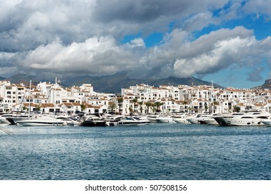 MARBELLA, SPAIN - OCTOBER 13: White expensive luxury yachts moored in the marina of Puerto Jose Banus on the Costa del Sol on a cloudy Autumn morning, on October 13, 2016.