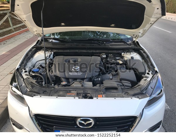 Marbella / Spain October 2, 2019: White\
Mazda engine, skyactiv technology. Open front bonnet. Vehicle\
engine Mazda 3, volume 2.0 G 88kW, year 2018\
editorial
