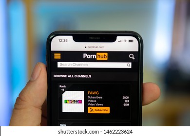 marbella,malaga/spain - 07 26 2019: left hand holding iphone xs max with internet browser open on pornhub, great for any article talking about mobile use of websites with adult content like porn hub.