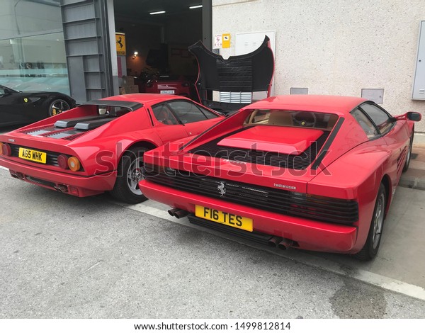 Marbella/Spain 5. September 2019: Two luxury\
Ferrari cars parking before service. Both are red color and one has\
an open front bonnet.\
editorial