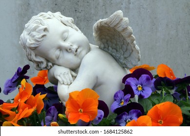 Marble Angel Statue In A Cemetery Among Flowers