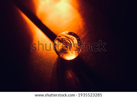Marble ball on a soft surface with blurry lights