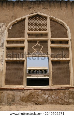 Marble Bara Darri is visible through intricate handcrafted marble mesh window of mughal era Lahore Fort built by Emperor Akbar and Jehangir.