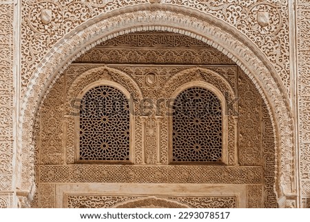  Marble capitals and stucco decoration of the portico in Patio del Cuarto Dorado in Mexuar in Comares Palace Alhambra, Andalusia, Spain. Magic breathtaking carved decoration  in orient style.