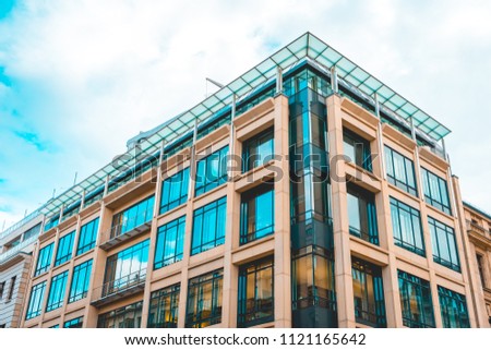 marble colored office building in the heart of berlin near unter den linden street with glass rooftop