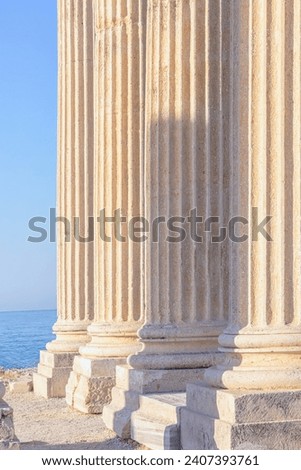 Marble columns with bases. Close up fragment, vertical. Corinthian order. Ruined temple of Apollo in Side Ancient city, Turkey (Turkiye). History, art or architecture concept