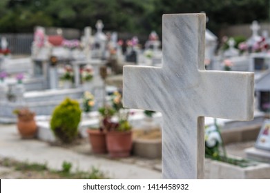 Marble cross in cemetery. Tomb decoration. Memorizing loved ones.