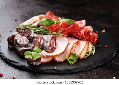 Marble Cutting Board With Prosciutto, Bacon, Salami And Sausages On Wooden Background. Meat Platter Appetizers 