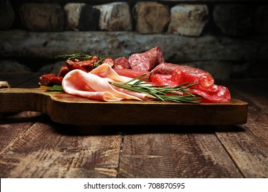 Marble Cutting Board With Prosciutto, Bacon, Salami And Sausages On Wooden Background. Meat Platter