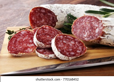 Marble cutting board with sliced salami on it
