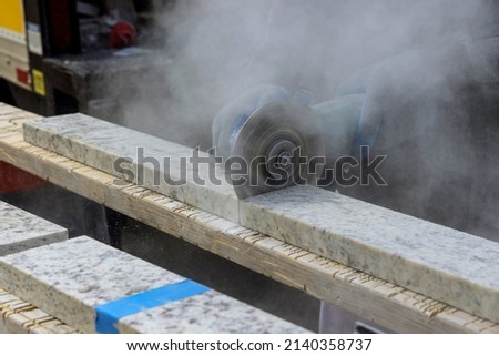 Marble cutting at construction site close up industrial tool, grinder piece of granite stone