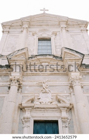 Marble facade with sculptures above the entrance of the Church of St. Ignatius. Dubrovnik, Croatia