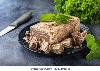 Marble halva on a plate in a cut with a knife.