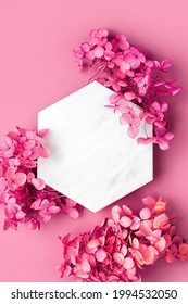 Marble  hexagon on pink background with flowers. Stylish background for presentation. - Shutterstock ID 1994532050