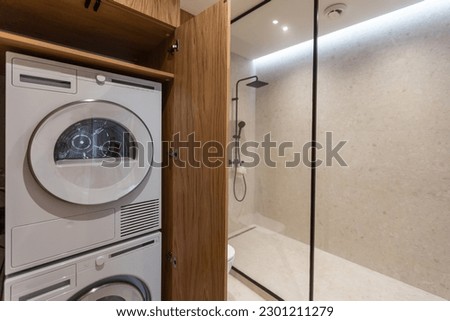 Marble laundry room interior with wooden countertops, a closet and built in washing machines Foto d'archivio © 