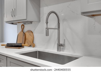 Marble Modern Kitchen Countertop with Deep Gray Sink, Commercial Style Faucet, Wooden Cutting Boards - Modern Farmhouse Kitchen Details - Powered by Shutterstock