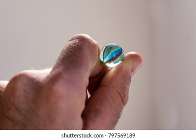A marble in one hand